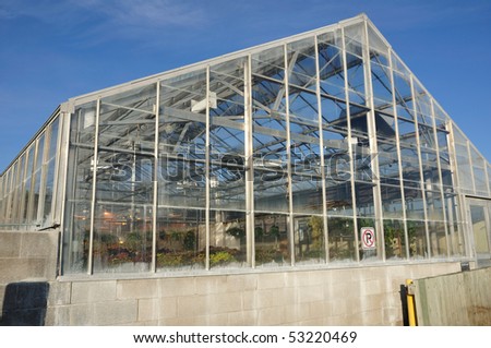 Greenhouse in Morning Light Against a Clear Blue Sky