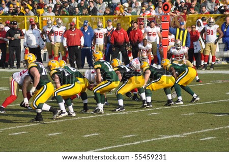 GREEN BAY, WI - NOVEMBER 22 : Green Bay Packers quarterback Aaron Rodgers takes the snap in a game at Lambeau Field against the San Francisco 49ers on November 22, 2009 in Green Bay, WI