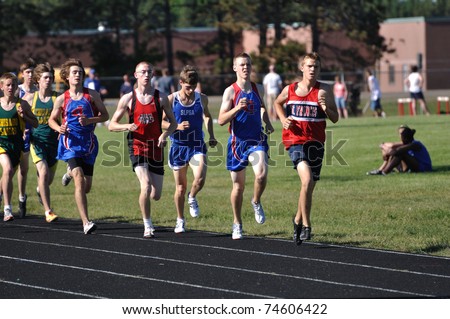 NORTH BRANCH, MN - MAY 27: Unidentified Teen Boys Running in a Long Distance High School Track Meet Race on May 27, 2010 in North Branch, Minnesota.
