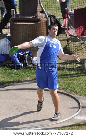 SPRING LAKE PARK, MN - May 3: Unidentified Teen Boy Throwing the Discus at a High School Track and Field Meet on May 3, 2011 in Spring Lake Park, Minnesota.
