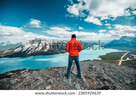 Similar – Foto Bild Mann in roter Jacke auf dem Felsen