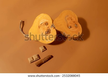 Similar – Image, Stock Photo Halved butternut squash on plate with cutlery and herbs at grey concrete kitchen table background.