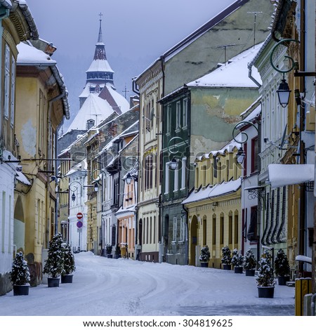 Brasov, Transylvania, Romania - December 28, 2014: A view of one of the main streets in downtown Brasov. This is a street with old building in the city leading to the medieval Black Church.