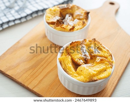 Similar – Image, Stock Photo Sweet bread pudding with orange zest butter