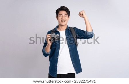 Similar – Image, Stock Photo Asian man with travel bag using smartphone against white wall