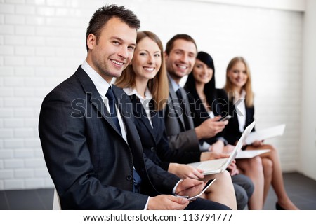 Group of happy business people sitting.