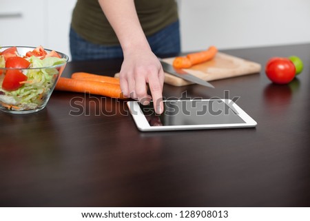 Checking recipe on digital tablet