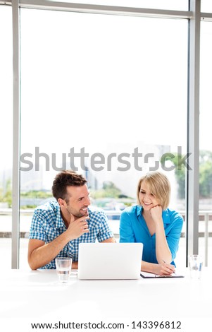 Teamwork concepts. Happy couple working together on laptop in the office.