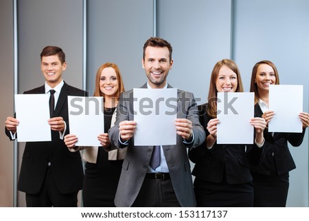 Business people holding blank paper cards