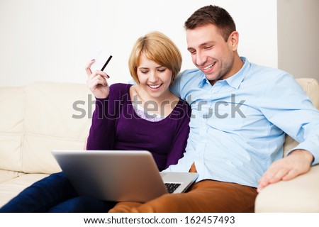 Young couple paying online with credit card