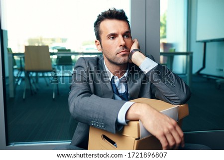 Unemployed fired from job businessman sitting at office floor thinking about his future ストックフォト © 