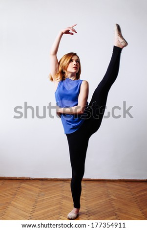 Ballet dancer stretching her leg