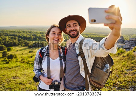 Similar – Foto Bild Junge Frau fotografiert Berge mit der Kamera