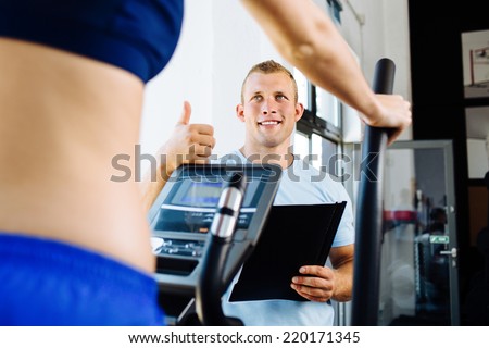 Photo of a fitness trainer praising his trainee