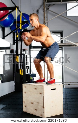 Young muscular man perfecting the box jump. Crossfit training