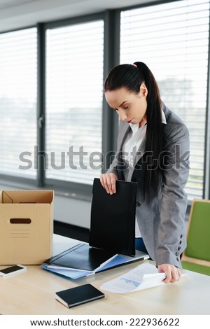 Photo of a female worker made redundant and packing her things