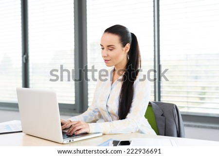 Photo of a young attractive lady working on her laptop