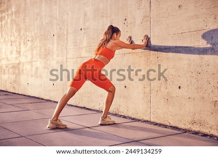 Similar – Image, Stock Photo Sportswoman stretching legs on stadium