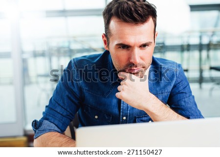 Young focused architect working on a laptop