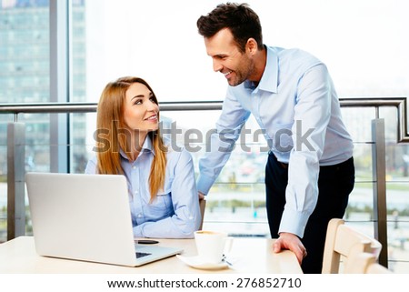 Two successful managers discussing business matters in an office