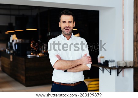 Successful restaurant manager standing with crossed arms