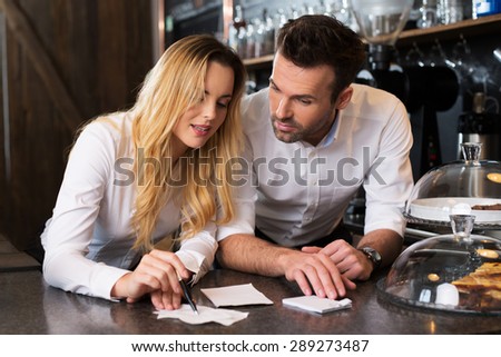 Two coffee shop owners discussing problem with recipes