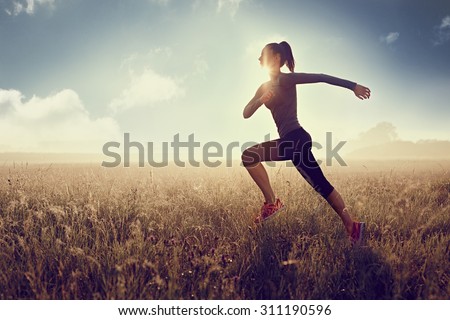 woman running at morning during sunset -  silhouette