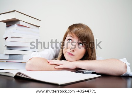 Student learning and dreaming with books on table