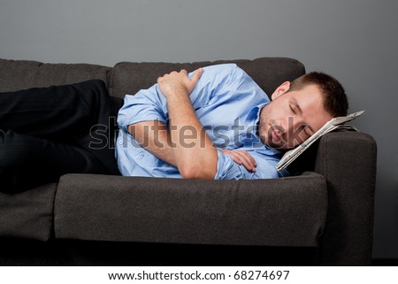Close-up of businessman sleeping on couch