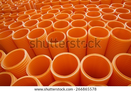 Large Group of Orange Industrial Plastic Pipes Full Frame