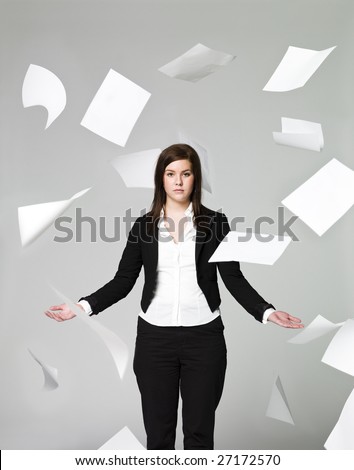 Office girl with a lots of papers flying around
