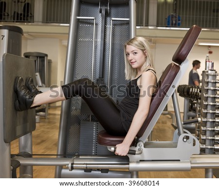 Girl exercing her legs at a health club
