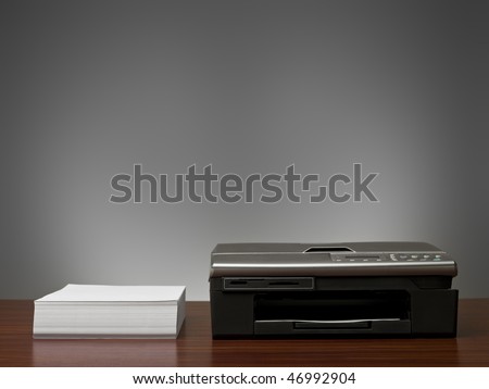 Copy Machine and a stack of  papers in an office