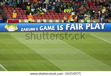 JOHANNESBURG - JUNE 20: Zakumi, the mascot of the South African 2010 Soccer World Cup is displayed on the borders of the football pitch indicating fair play at Ellis Park Stadium, South Africa on June 20, 2010