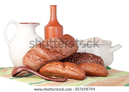 bread, clay jug, big spoon, bottle, oat flakes, towel on a white background