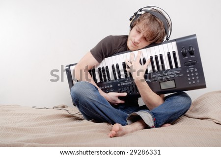 Man hugs a MIDI-keyboard