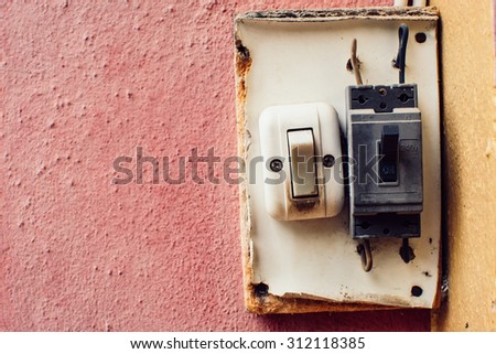 Old switch on the pink wall