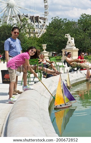 Paris, France - July 7, 2011 - Both Parisians and tourists enjoy a sunny afternoon at the Tuileries Garden (Jardin des Tuileries) in Paris.