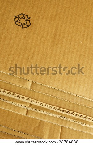 Brown packaging cardboard background with a recycle symbol