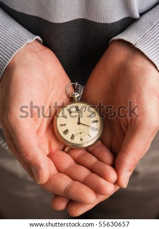 person holding old pocket watch in his hand