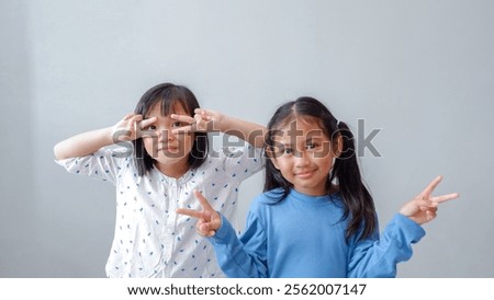 Similar – Image, Stock Photo Female palm with V-sign with rainbow bracelet