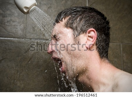 A man taking a shower with his mouth open.
