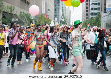 Toronto June 28, 2015 The 35th Toronto Pride Parade 2015 takes place along Bloor and Yonge Streets. Parade-goers line the streets and revellers party hard despite the rainy weather.