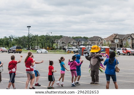 Milton, Canada June 23, 2015: Pachi, the Pan Am mascot interacts with the crowd at the Pan Am Relay Torch Lighting Ceremony in Milton, Ontario.