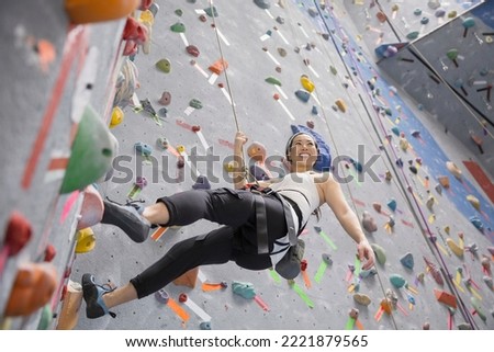 Similar – Image, Stock Photo Woman rock climbing indoors.