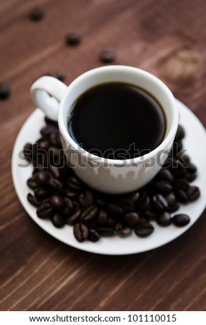 cup black coffee on a lot of coffee beans