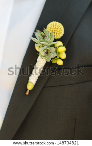 Groomsmen in black wedding suits wearing rose boutonnieres
