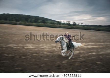 Freedom concept, young blonde woman galloping on white horse