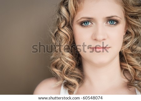 Portrait of naturally beautiful woman in her twenties with blond hair and blue eyes