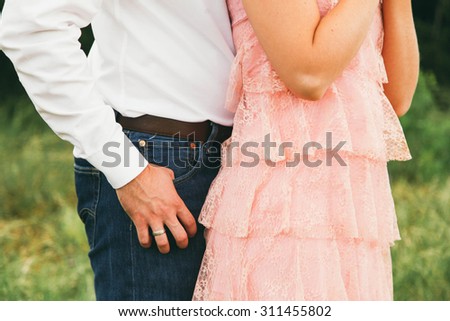 Western Couple Posing in Green Field